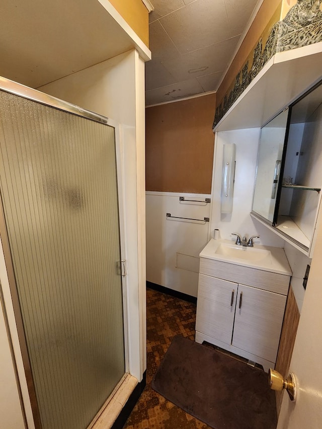 bathroom with a shower with door and vanity