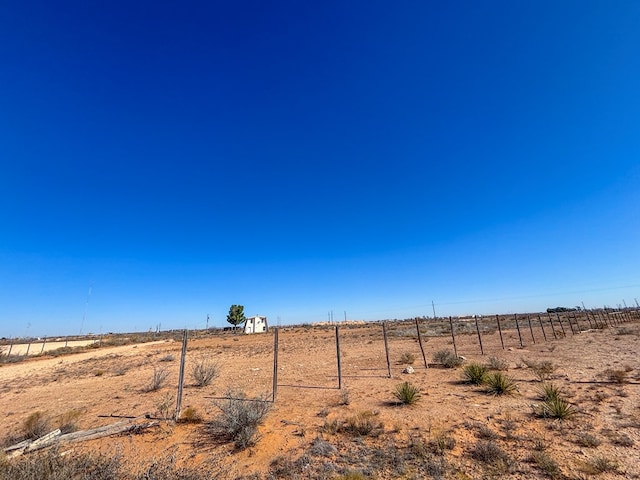 view of yard with a rural view and fence