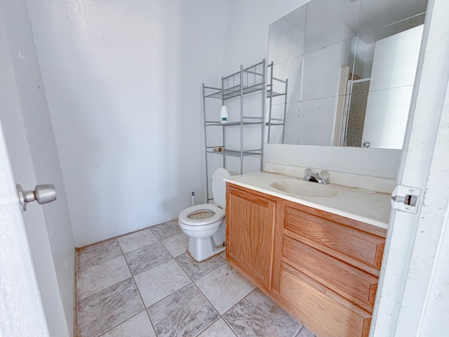 bathroom featuring toilet and vanity