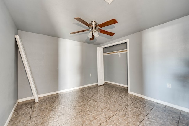 unfurnished bedroom with tile patterned flooring, ceiling fan, and a closet