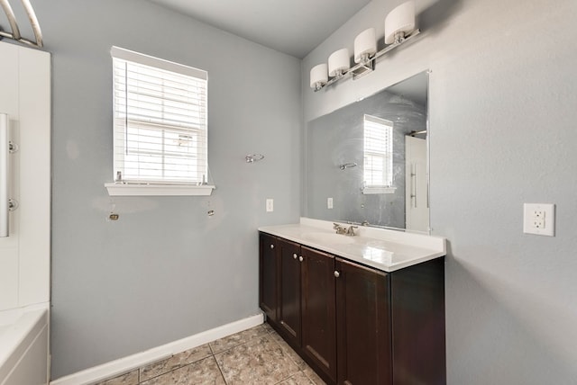 bathroom with vanity, tile patterned flooring, a wealth of natural light, and shower / bathing tub combination