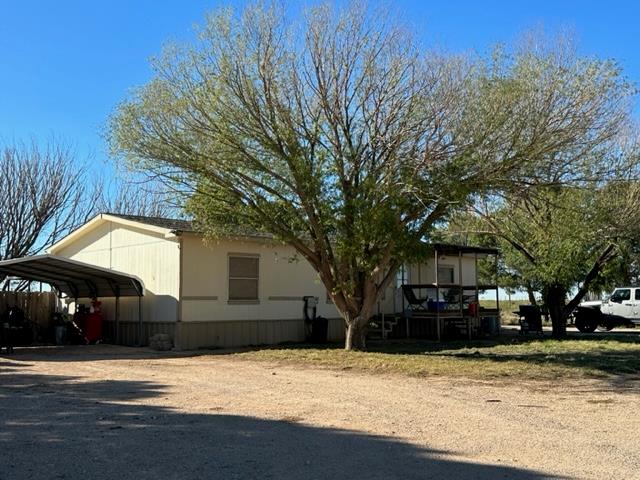 view of side of property with a carport