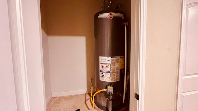 utility room featuring water heater