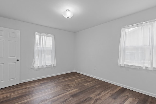 unfurnished room with dark hardwood / wood-style floors