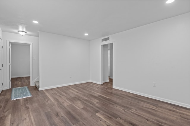 spare room with dark wood-type flooring