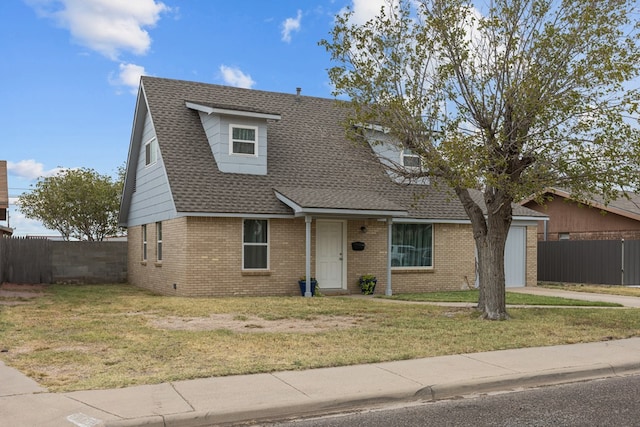 view of front of house featuring a front yard and a garage