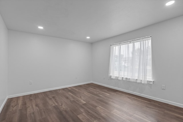 unfurnished room featuring dark hardwood / wood-style flooring