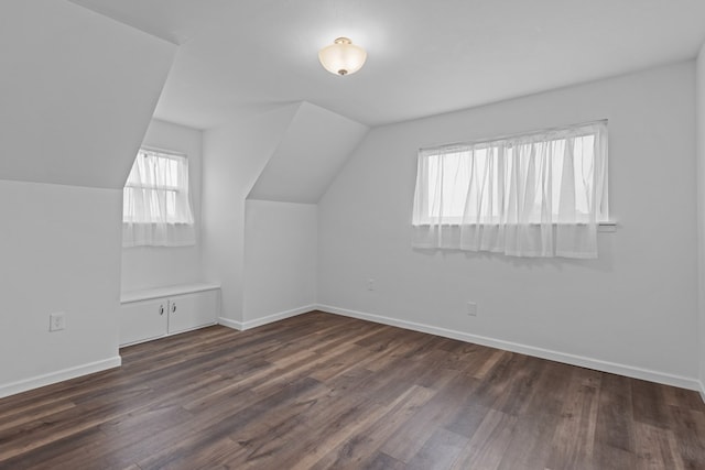 bonus room featuring dark hardwood / wood-style flooring and vaulted ceiling