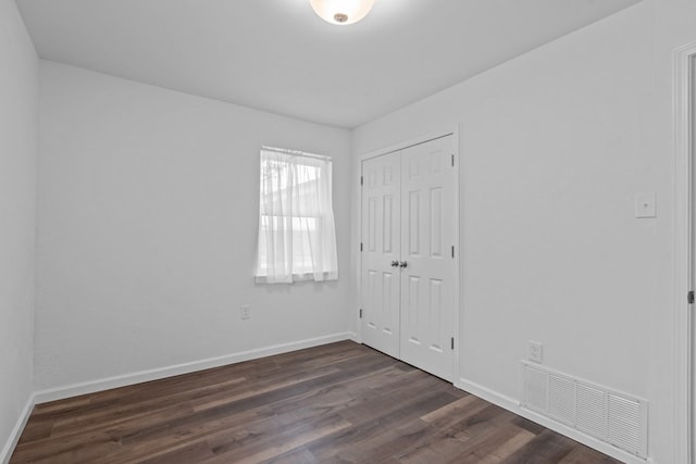 spare room featuring dark hardwood / wood-style floors