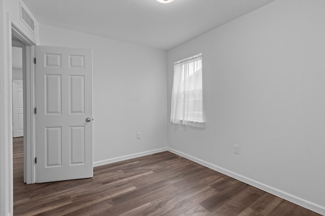 spare room featuring dark hardwood / wood-style flooring