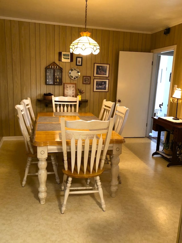 dining room with wood walls