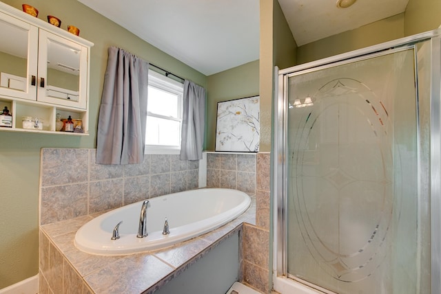 bathroom featuring shower with separate bathtub