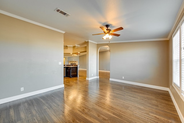 unfurnished living room featuring crown molding, plenty of natural light, ceiling fan, and dark wood-type flooring