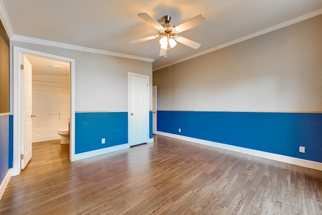 unfurnished bedroom featuring ceiling fan, crown molding, wood-type flooring, connected bathroom, and a closet