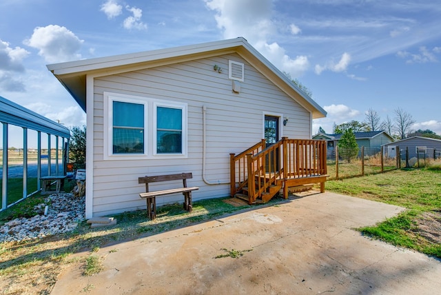 back of property featuring a yard