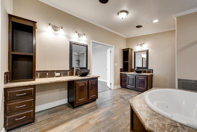 bathroom with wood-type flooring, vanity, separate shower and tub, and ornamental molding