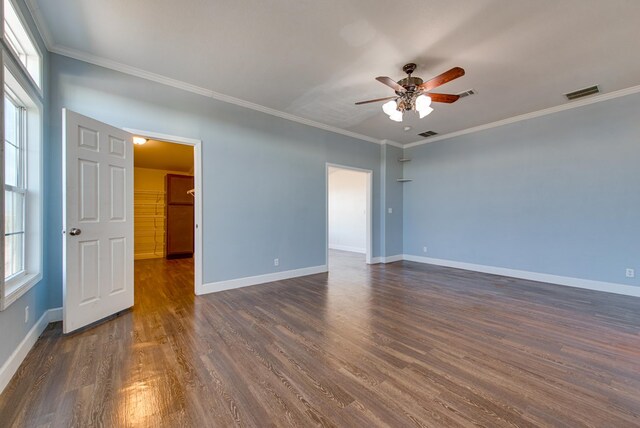 unfurnished room with crown molding, dark hardwood / wood-style flooring, and ceiling fan