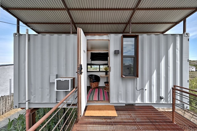 view of exterior entry featuring a wall mounted AC