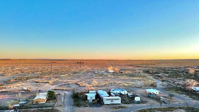 aerial view at dusk featuring a rural view