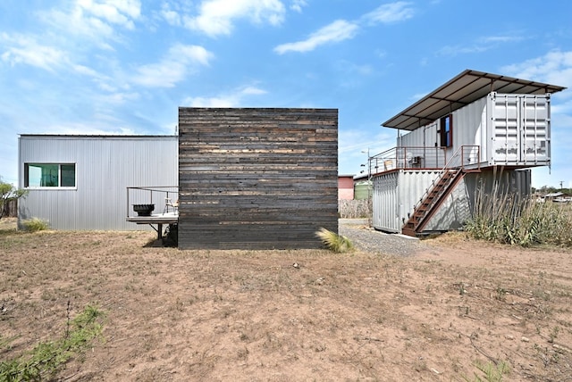 view of outbuilding featuring stairs