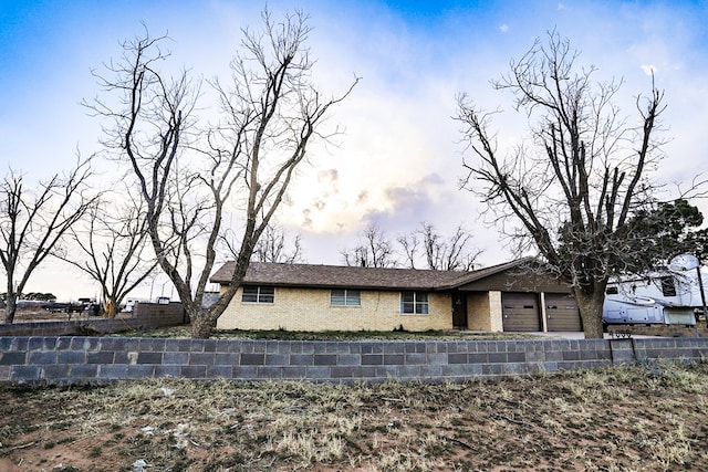 view of front of house with a garage and fence