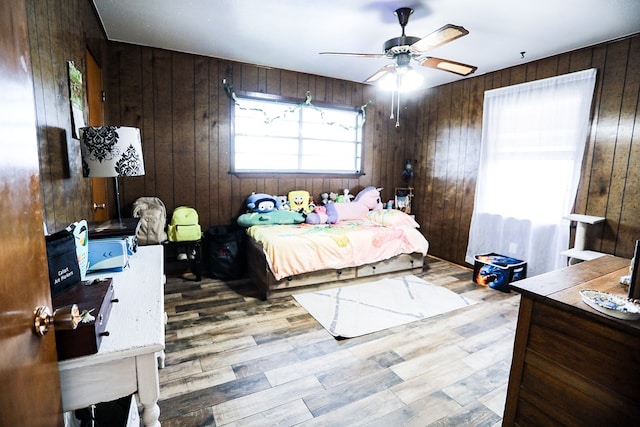 bedroom with wood finished floors and wood walls