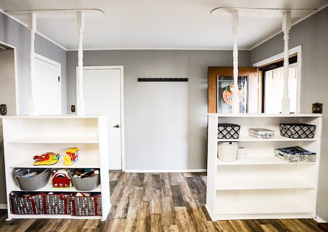 interior space with crown molding and wood finished floors