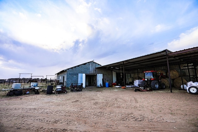 exterior space featuring a carport and an outdoor structure