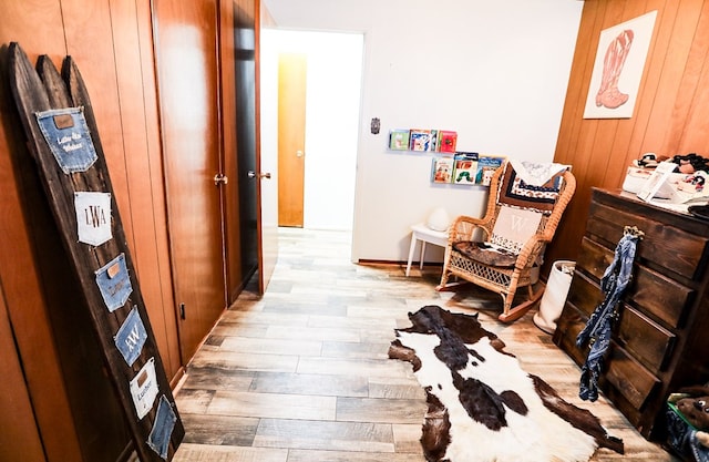 corridor with baseboards and wood finished floors