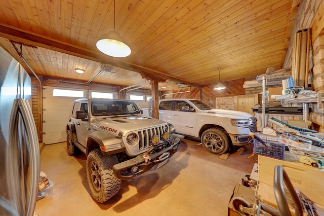 garage with stainless steel fridge, wooden walls, and wood ceiling