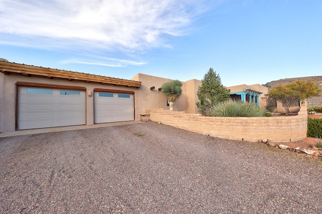 pueblo-style home with a garage