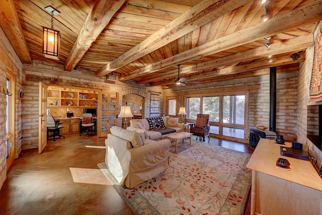 living room featuring beam ceiling, a wood stove, ceiling fan, and wood ceiling