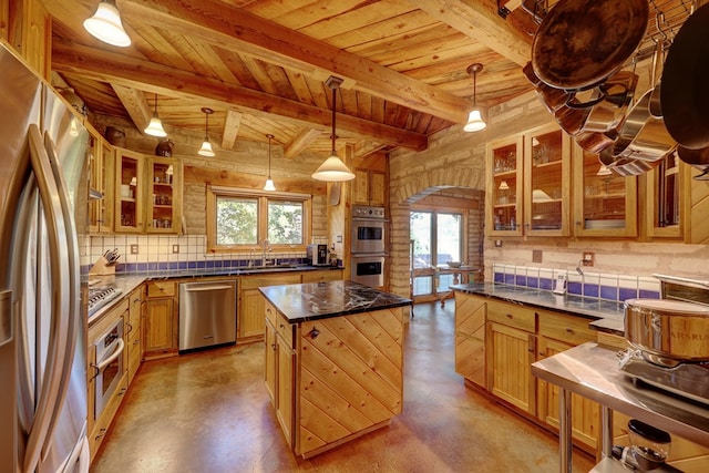 kitchen featuring hanging light fixtures, plenty of natural light, a kitchen island, and stainless steel appliances