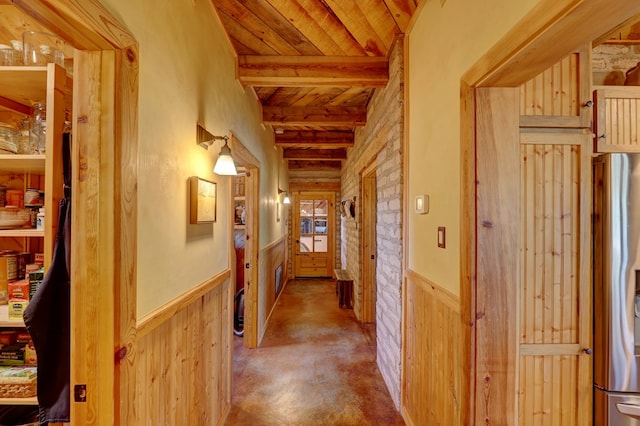 corridor featuring beam ceiling, wooden ceiling, and wooden walls