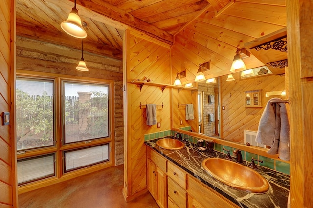 bathroom with lofted ceiling with beams, wood walls, vanity, and wooden ceiling