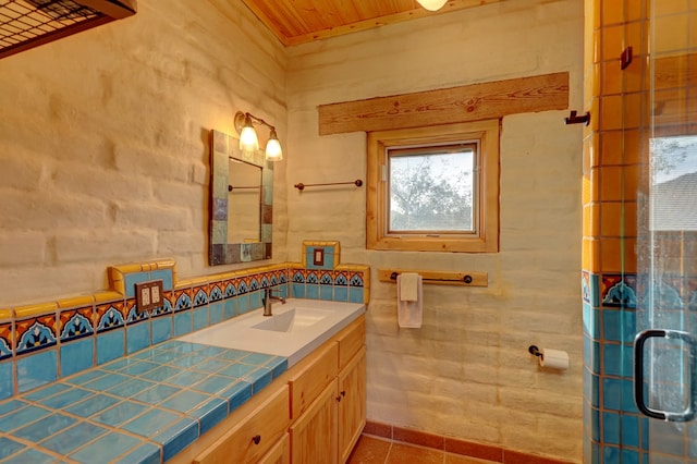 bathroom with tile patterned flooring, vanity, an enclosed shower, and wooden ceiling