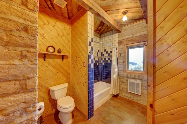 bathroom featuring beam ceiling, toilet, wooden walls, wood ceiling, and shower / tub combo