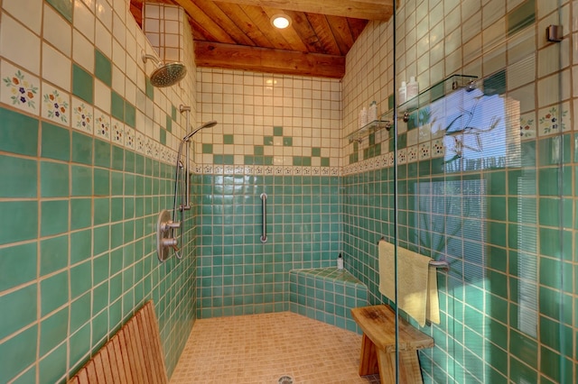 bathroom featuring beamed ceiling, wooden ceiling, tile walls, and walk in shower