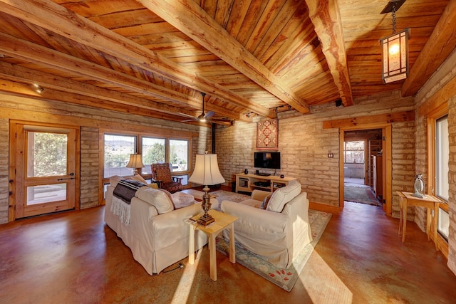 living room featuring ceiling fan, wooden ceiling, beamed ceiling, brick wall, and concrete flooring