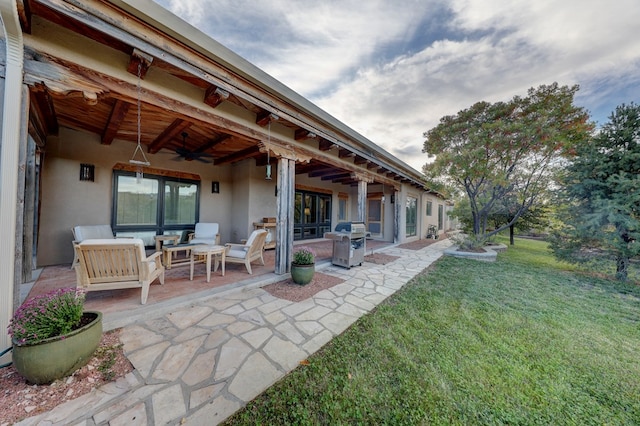 view of yard featuring an outdoor living space, ceiling fan, and a patio