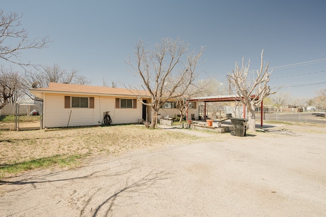 view of front of house with a patio area and fence