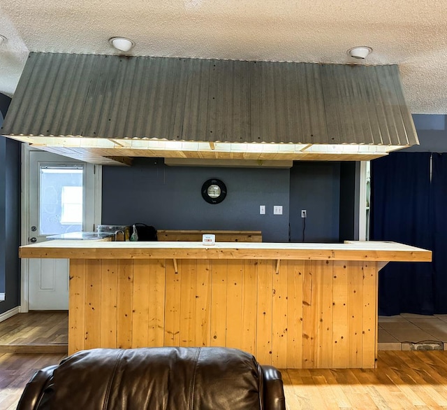 interior space with hardwood / wood-style floors and a textured ceiling