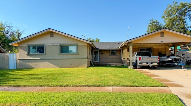 view of front of property with a front yard and a carport