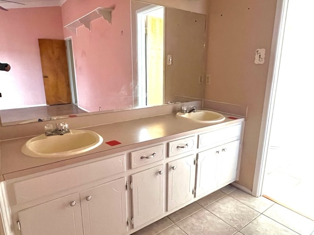 bathroom featuring a sink, double vanity, and tile patterned floors