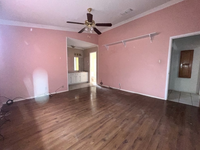 unfurnished living room with ceiling fan, wood finished floors, and ornamental molding