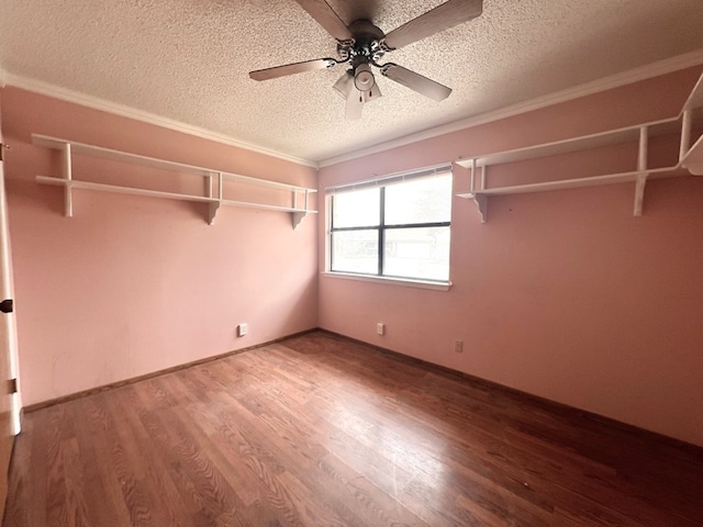 unfurnished bedroom with ceiling fan, ornamental molding, wood finished floors, and a textured ceiling