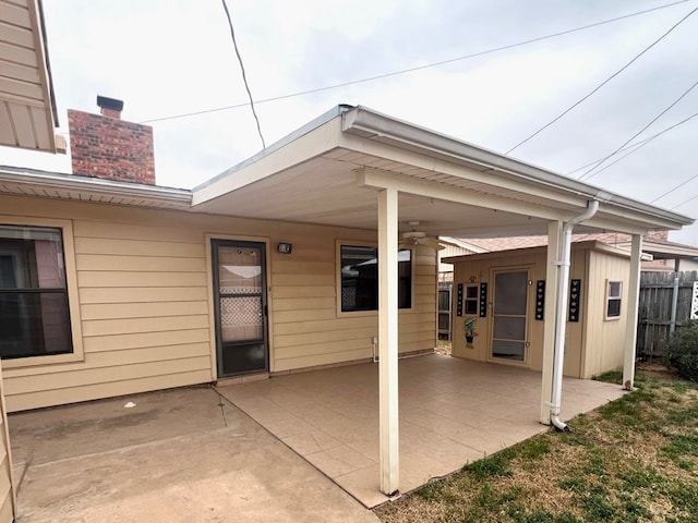 view of patio / terrace featuring fence and ceiling fan