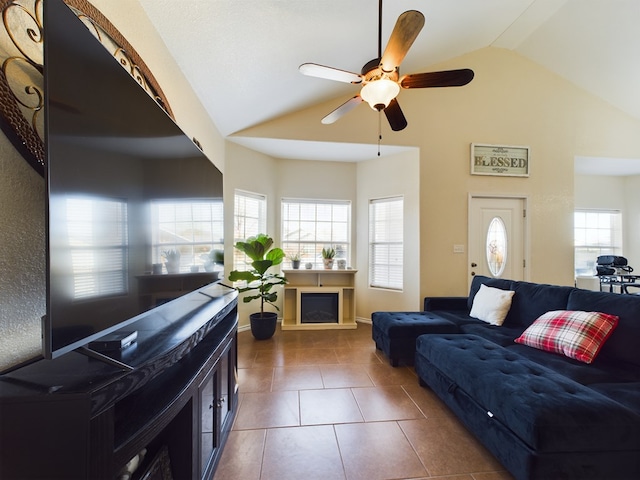 living room with dark tile patterned floors, vaulted ceiling, ceiling fan, and plenty of natural light