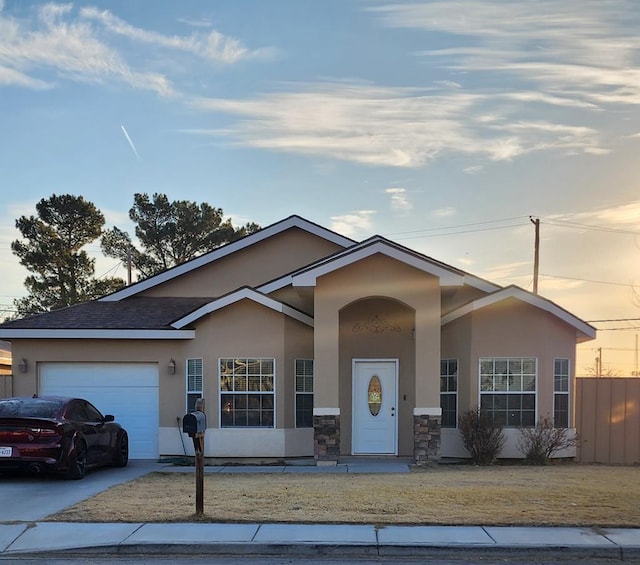 single story home with a lawn and a garage