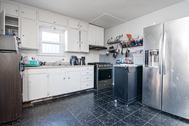 kitchen with appliances with stainless steel finishes, white cabinetry, and sink